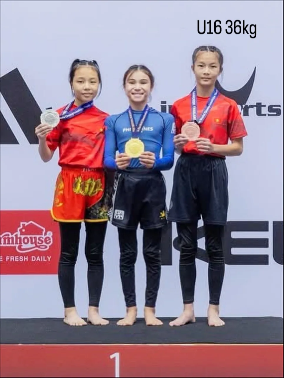 Bailey Heinsohn on the podium after winning U16 Female -36 kg No-Gi gold at the 2025 JJIF World Championships in Bangkok, Thailand.