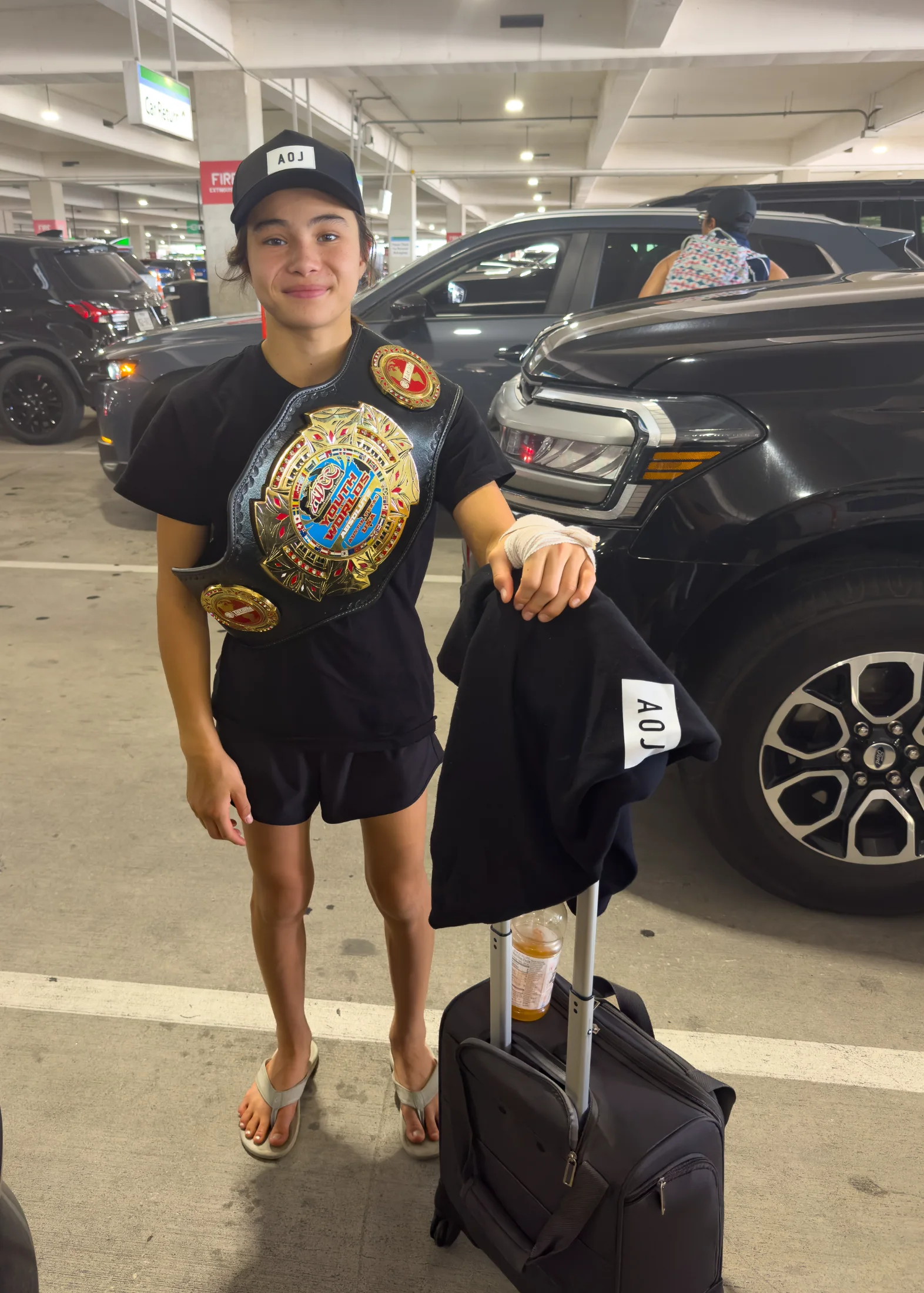 Bailey Heinsohn leaving the 2026 ADCC Youth World Championships in Austin, Texas, wearing one of her championship belts after winning double gold.