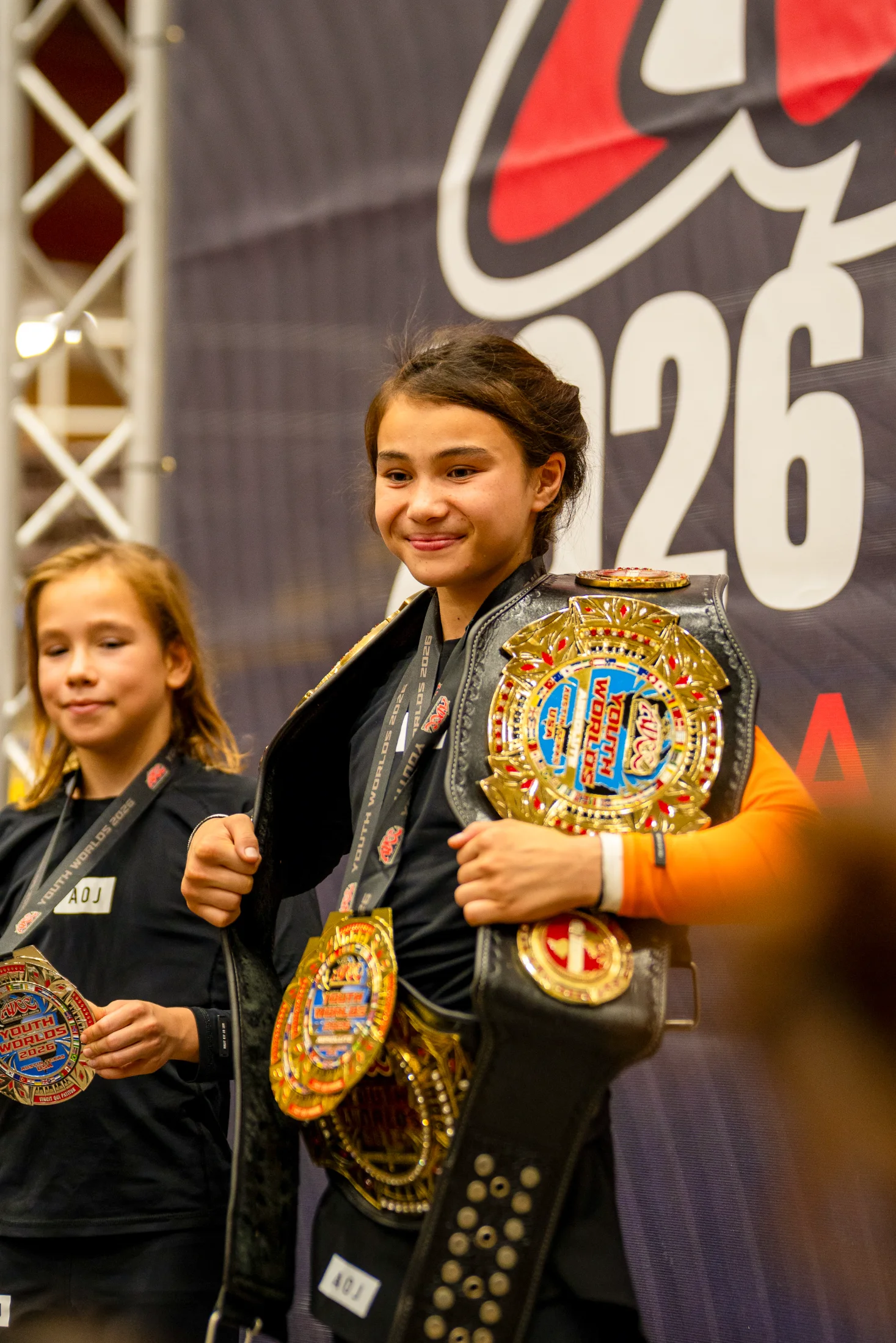 Bailey Heinsohn and Sahara Wells on the podium at the 2026 ADCC Youth World Championships in Austin, Texas, after the 40 kg division final.
