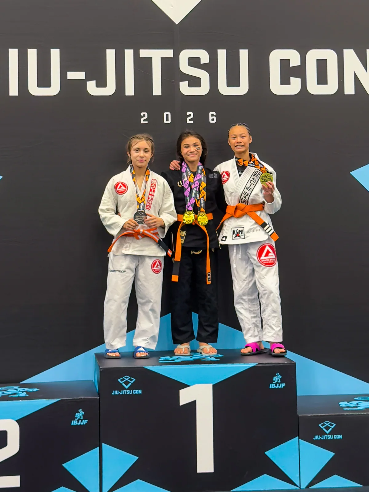 Bailey Heinsohn standing on the podium with her gold medal after winning the Gi division at the 2026 IBJJF Jiu-Jitsu CON in Las Vegas.