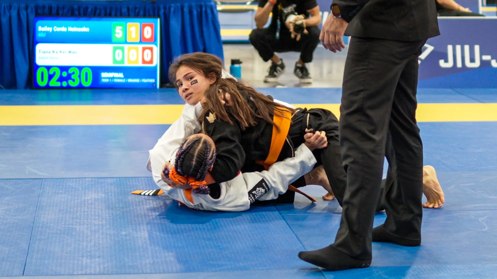 Bailey Heinsohn in top position against Tiana Ka Kei Wan during their Gi match at the 2026 IBJJF Jiu-Jitsu CON in Las Vegas.