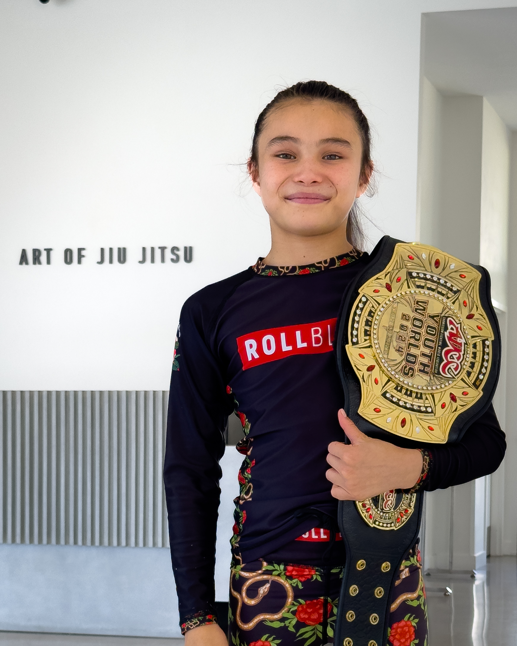 Bailey Heinsohn at Art of Jiu Jitsu with her 2024 ADCC Youth Champion Belt
