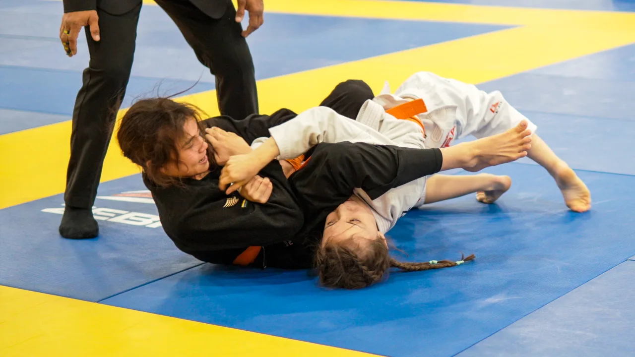 Bailey Heinsohn applying an armbar against Jazmyn Alexis Lopez during the Gi final at the 2026 IBJJF Jiu-Jitsu CON in Las Vegas.