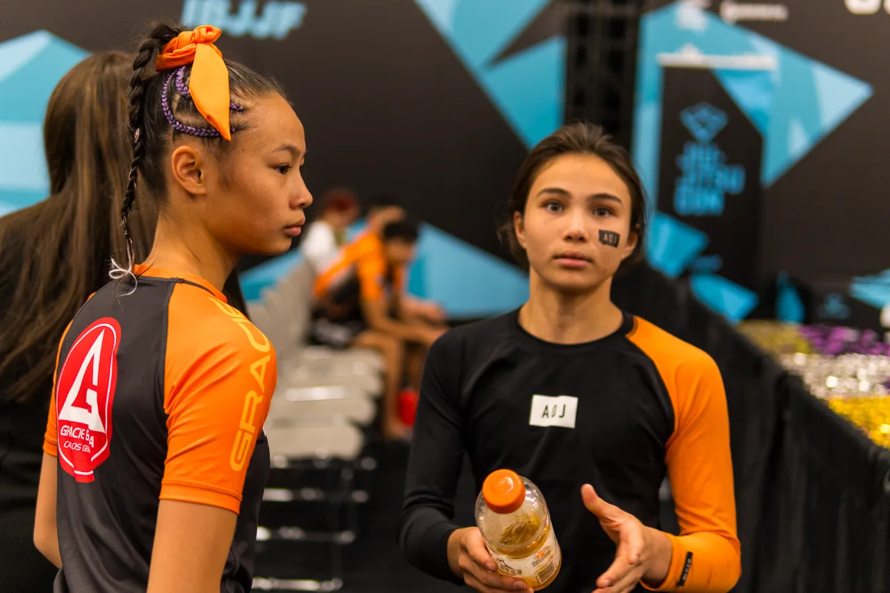 Bailey Heinsohn and Tiana Ka Kei Wan near the competition area before their No-Gi final at the 2026 IBJJF Jiu-Jitsu CON in Las Vegas.